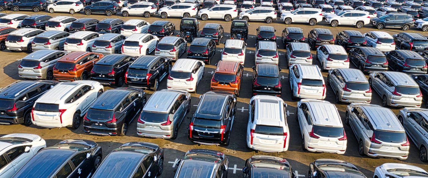 Rows of vehicles filling a marshalling lot, photographed from above.